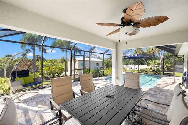 view of patio / terrace with ceiling fan and a lanai