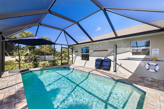 view of swimming pool featuring a lanai and a patio