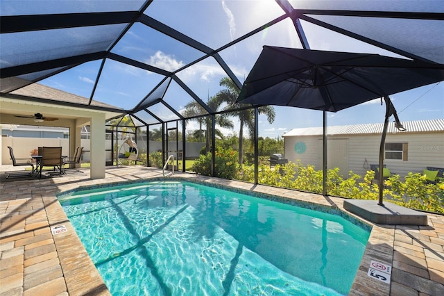 view of swimming pool featuring ceiling fan, a patio, and glass enclosure