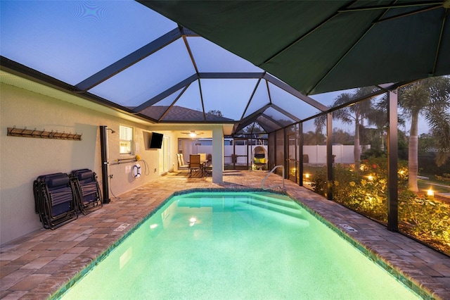 view of pool featuring a lanai, ceiling fan, and a patio