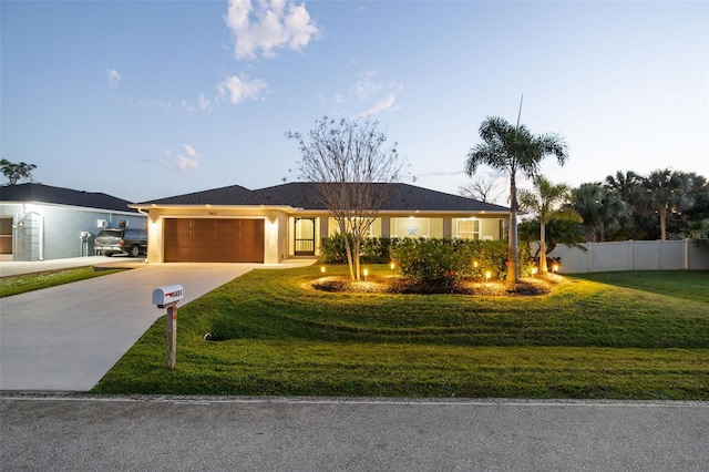 single story home with a yard and a garage