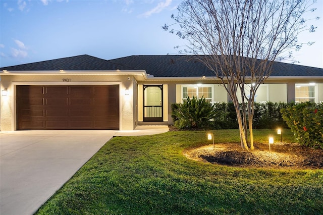 ranch-style house with a lawn and a garage