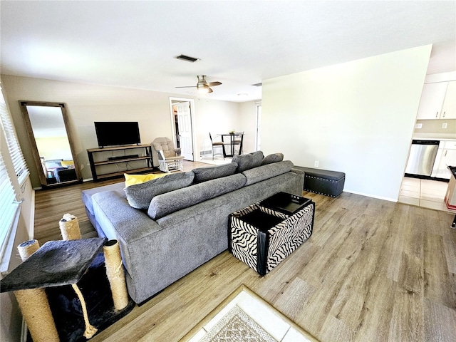 living room featuring light wood-type flooring and ceiling fan