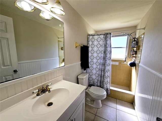 full bathroom with vanity, tile patterned floors, toilet, and shower / tub combo