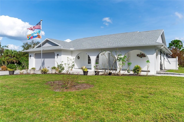 ranch-style house with a garage and a front lawn