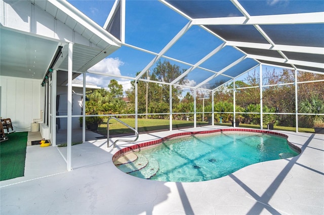 view of swimming pool featuring a patio area and a lanai