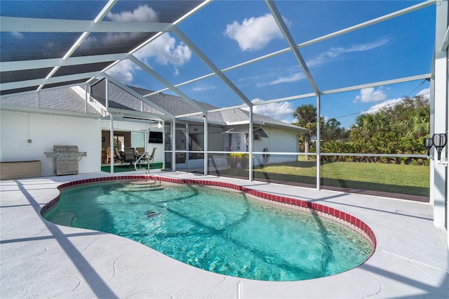 view of pool with a lanai, a grill, a lawn, and a patio area