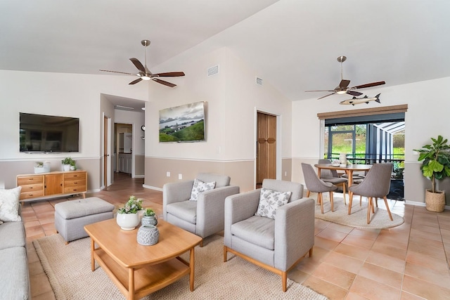 tiled living room with lofted ceiling and ceiling fan