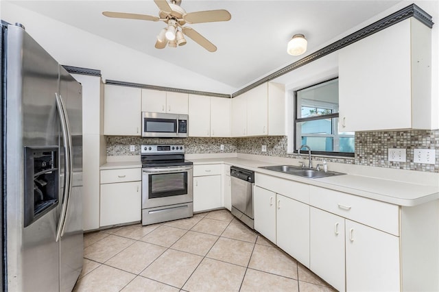 kitchen featuring white cabinetry, sink, vaulted ceiling, and appliances with stainless steel finishes