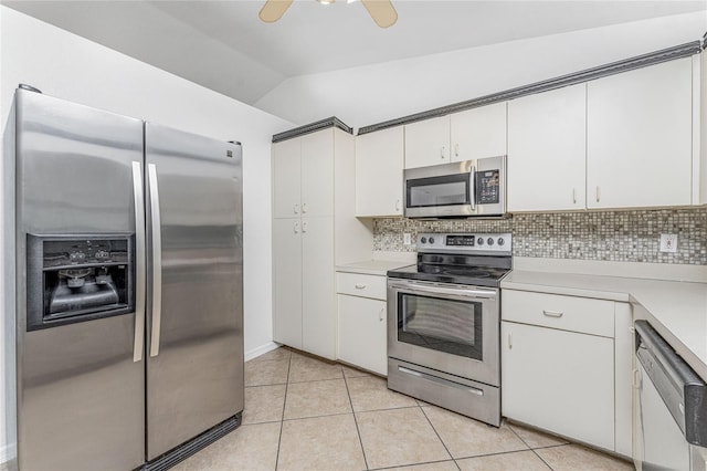 kitchen with white cabinets, decorative backsplash, stainless steel appliances, and vaulted ceiling