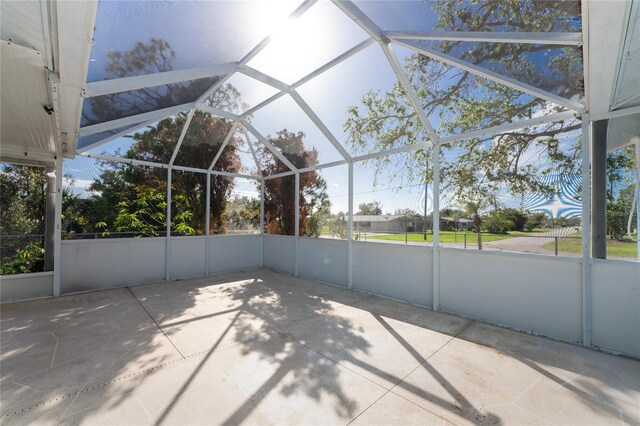 view of patio featuring glass enclosure