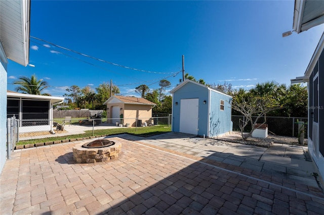 view of patio featuring a storage unit and an outdoor fire pit