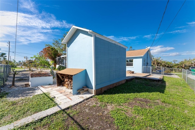 view of home's exterior featuring an outbuilding and a yard