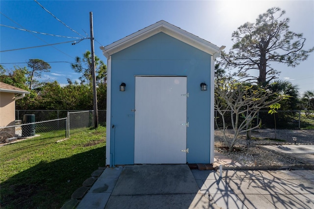view of outbuilding with a lawn
