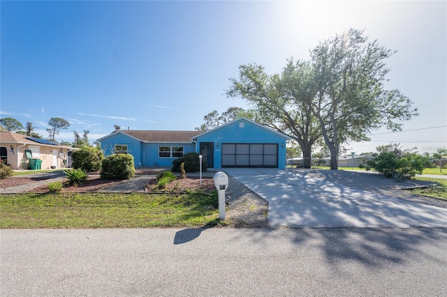 ranch-style home with a garage and a front lawn