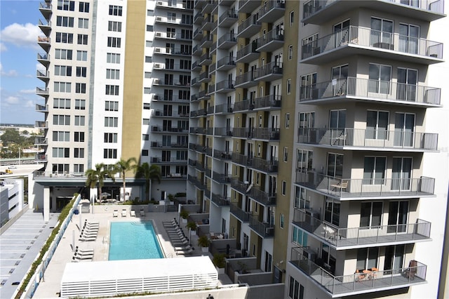 view of building exterior featuring a community pool