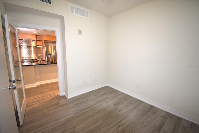 empty room with dark wood-type flooring