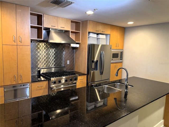 kitchen featuring decorative backsplash, appliances with stainless steel finishes, ventilation hood, sink, and dark stone countertops