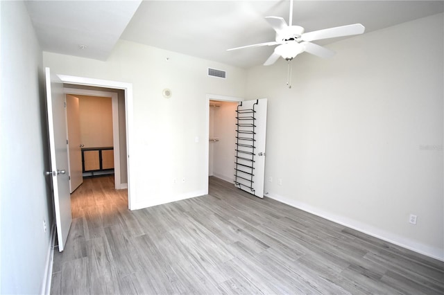 unfurnished bedroom with ceiling fan and light hardwood / wood-style floors