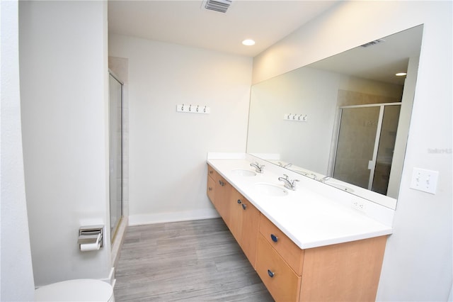 bathroom featuring vanity, toilet, and walk in shower