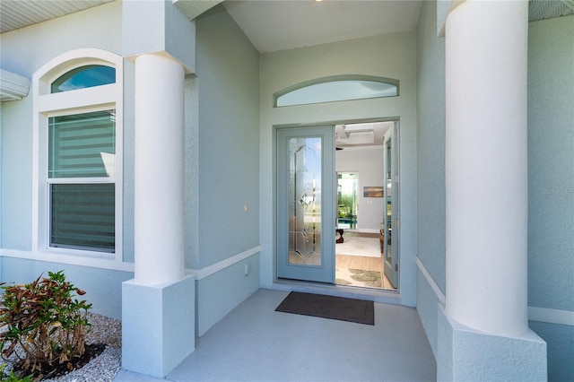 view of exterior entry with an AC wall unit