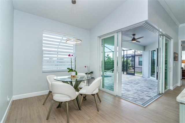 dining area featuring lofted ceiling and light hardwood / wood-style flooring