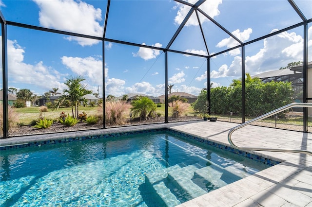 view of pool featuring a patio area and glass enclosure