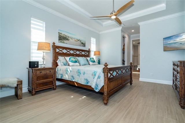 bedroom featuring a raised ceiling, crown molding, ceiling fan, and light hardwood / wood-style flooring