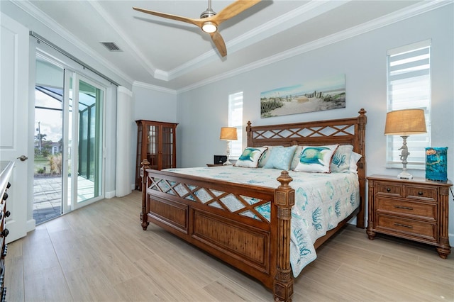 bedroom with crown molding, access to outside, light wood-type flooring, and a tray ceiling