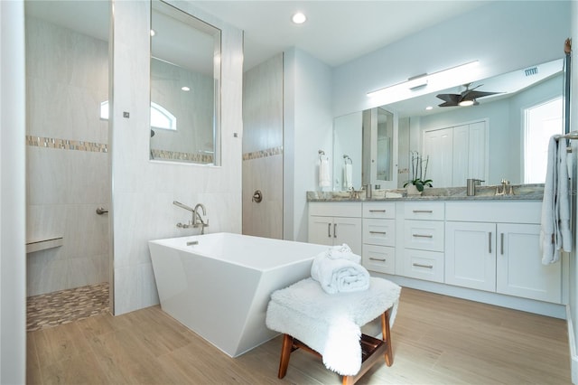 bathroom with vanity, separate shower and tub, hardwood / wood-style floors, and ceiling fan