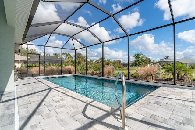 view of swimming pool featuring a lanai and a patio area