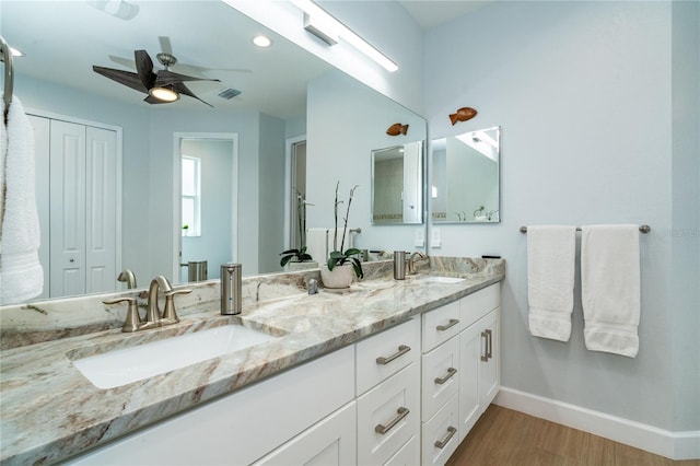 bathroom with vanity, hardwood / wood-style floors, and ceiling fan