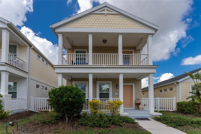 view of front of home with covered porch and a balcony