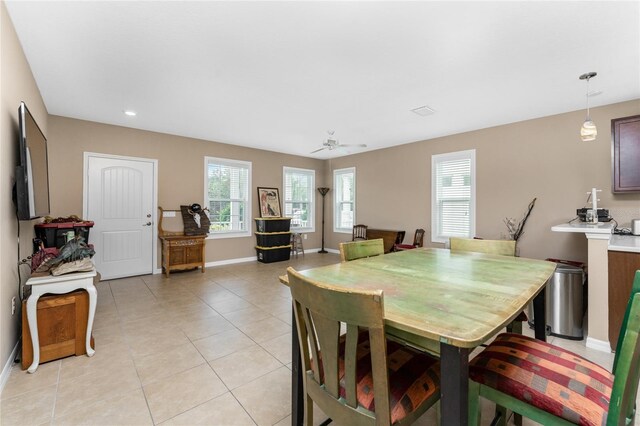 dining space with light tile patterned floors and ceiling fan