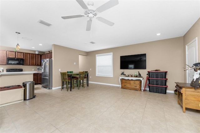 living room featuring ceiling fan and light tile patterned floors