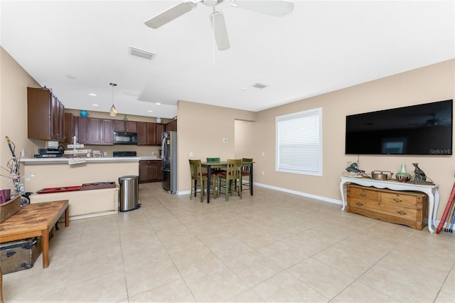 tiled living room with ceiling fan