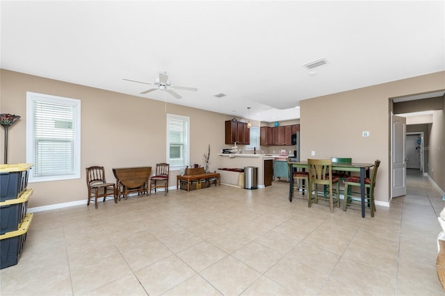 living room featuring light tile patterned floors and ceiling fan