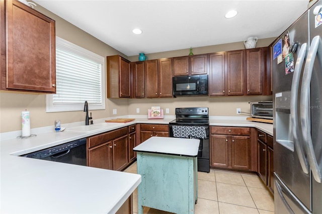 kitchen featuring light tile patterned flooring, sink, a kitchen island, and black appliances