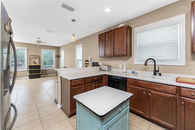 kitchen featuring sink, hanging light fixtures, ceiling fan, black dishwasher, and kitchen peninsula