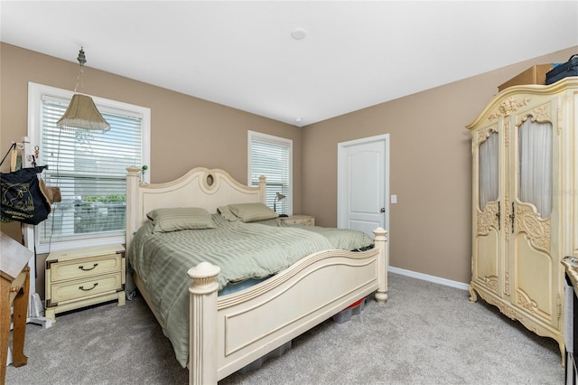 carpeted bedroom with multiple windows