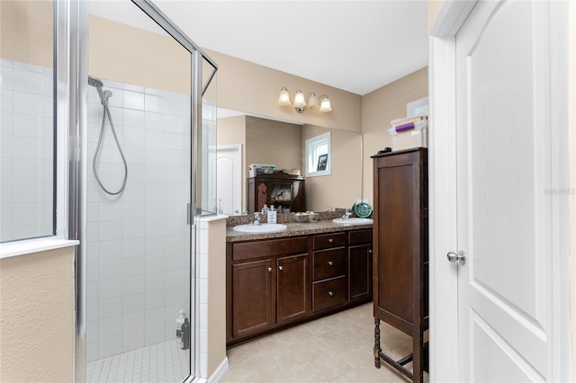 bathroom featuring tile patterned flooring, vanity, and walk in shower