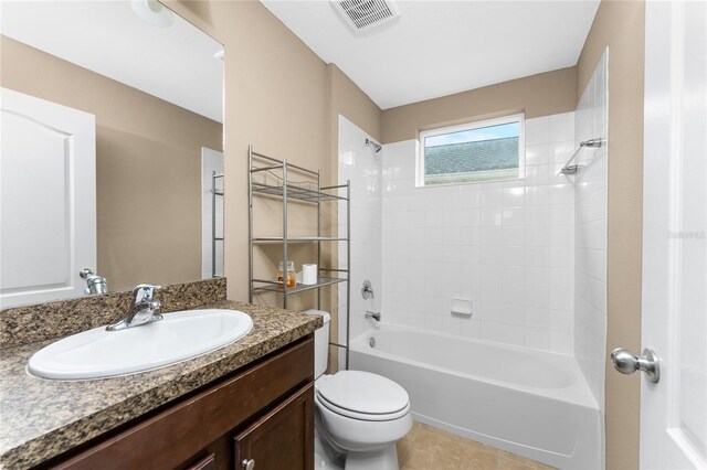 full bathroom with tile patterned floors, vanity, toilet, and tiled shower / bath