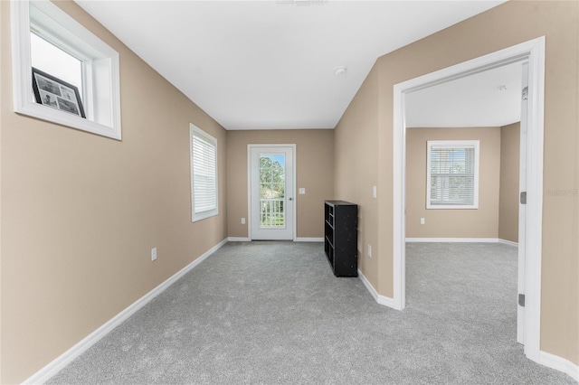 unfurnished living room featuring light carpet