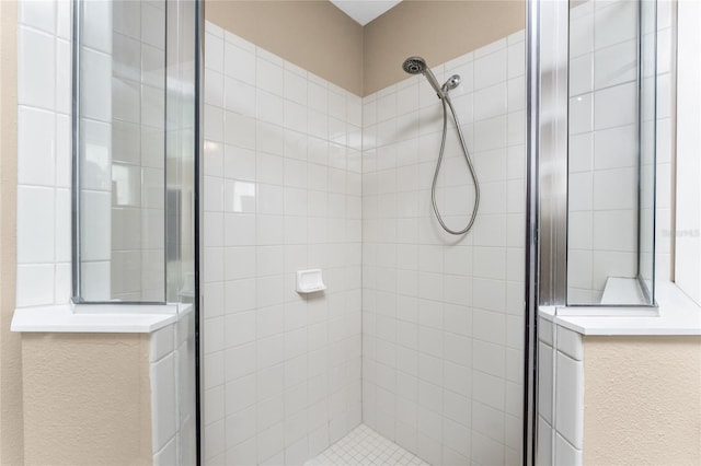 bathroom with tiled shower