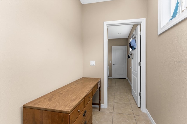 corridor with light tile patterned floors