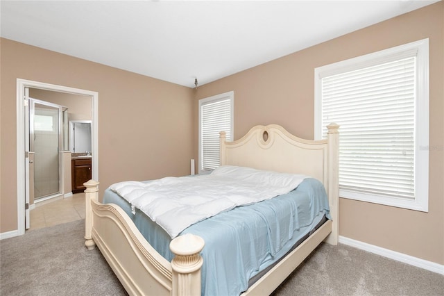 12753 Sagewood Dr, Venice, FL 34293 - bedroom with light colored carpet and ensuite bathroom