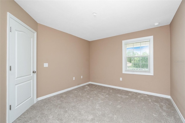 12753 Sagewood Dr, Venice, FL 34293 - carpeted empty room featuring baseboards and a smoke detector