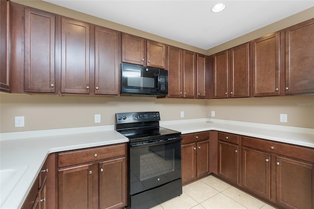12753 Sagewood Dr, Venice, FL 34293 - kitchen featuring black appliances, light tile patterned floors, light countertops, and recessed lighting
