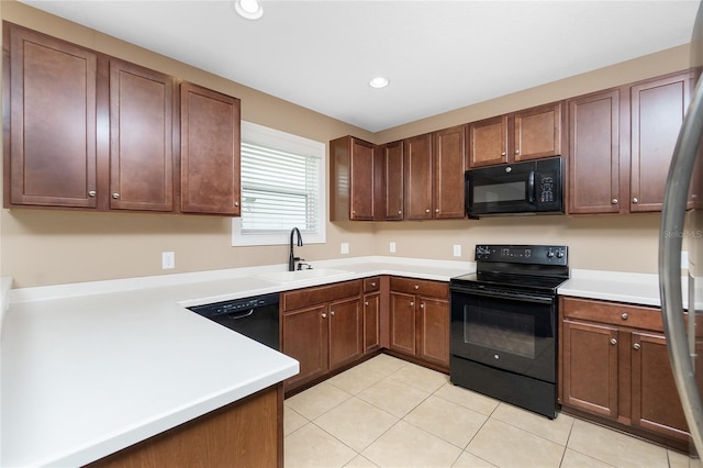 12753 Sagewood Dr, Venice, FL 34293 - kitchen with black appliances, light tile patterned floors, light countertops, and recessed lighting