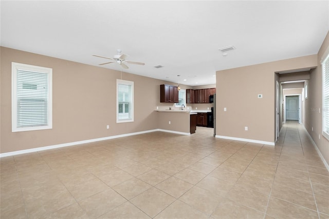 12753 Sagewood Dr, Venice, FL 34293 - unfurnished living room with light tile patterned floors and ceiling fan